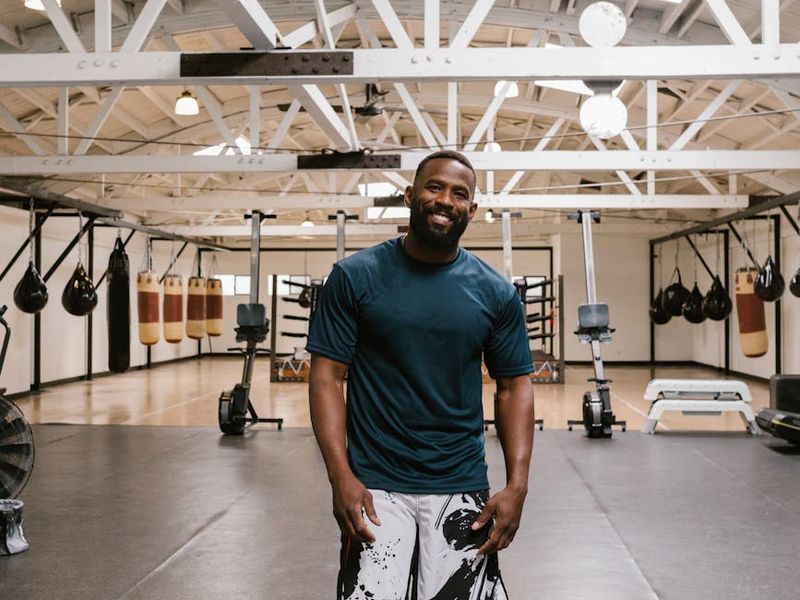 Group of diverse people smiling during a light fitness activity.